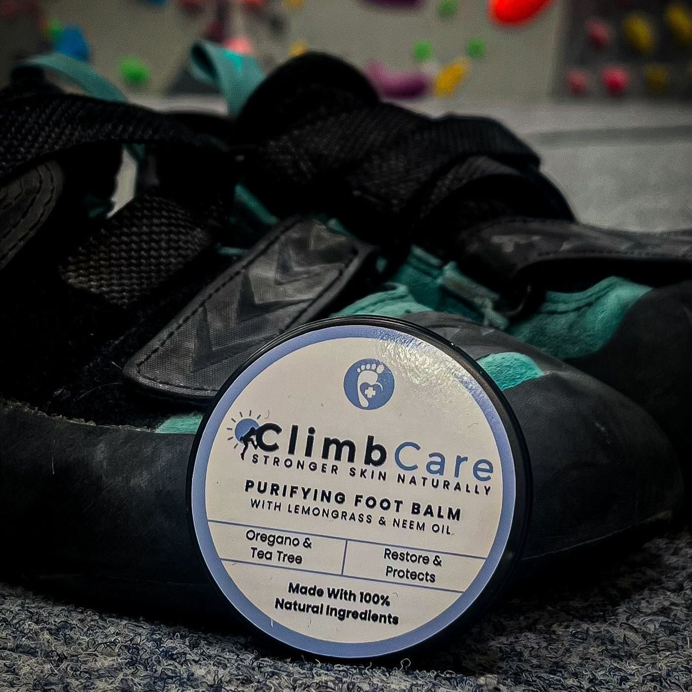 Climb Care foot balm with climbing shoes in the background