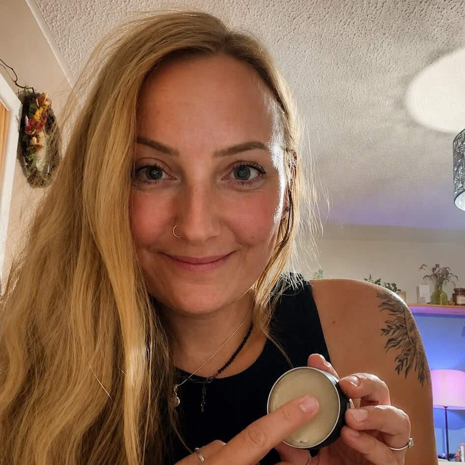 Woman holding a tin of climbcare natural deodorant